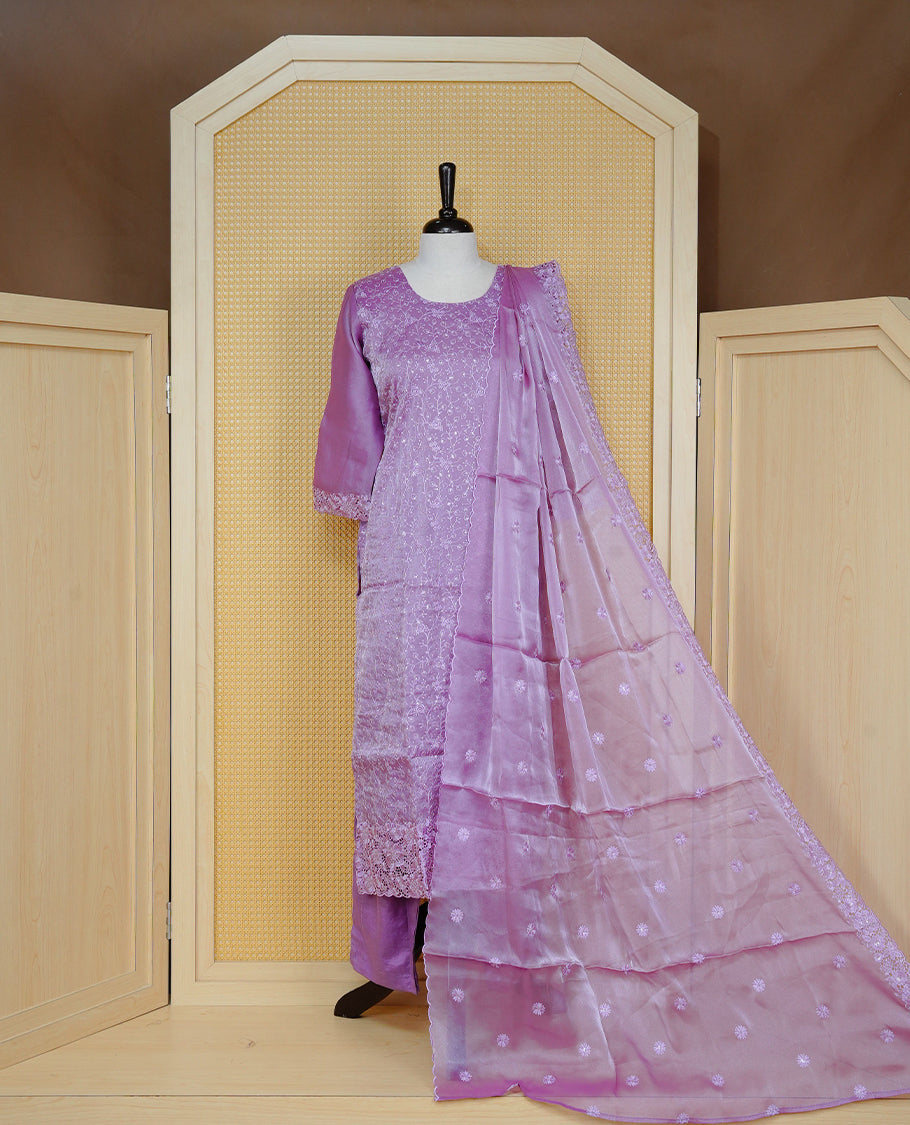 Lavender colour churidar set with floral thread embroidery on body & round neckline, paired with a matching embroidered dupatta and solid pants.