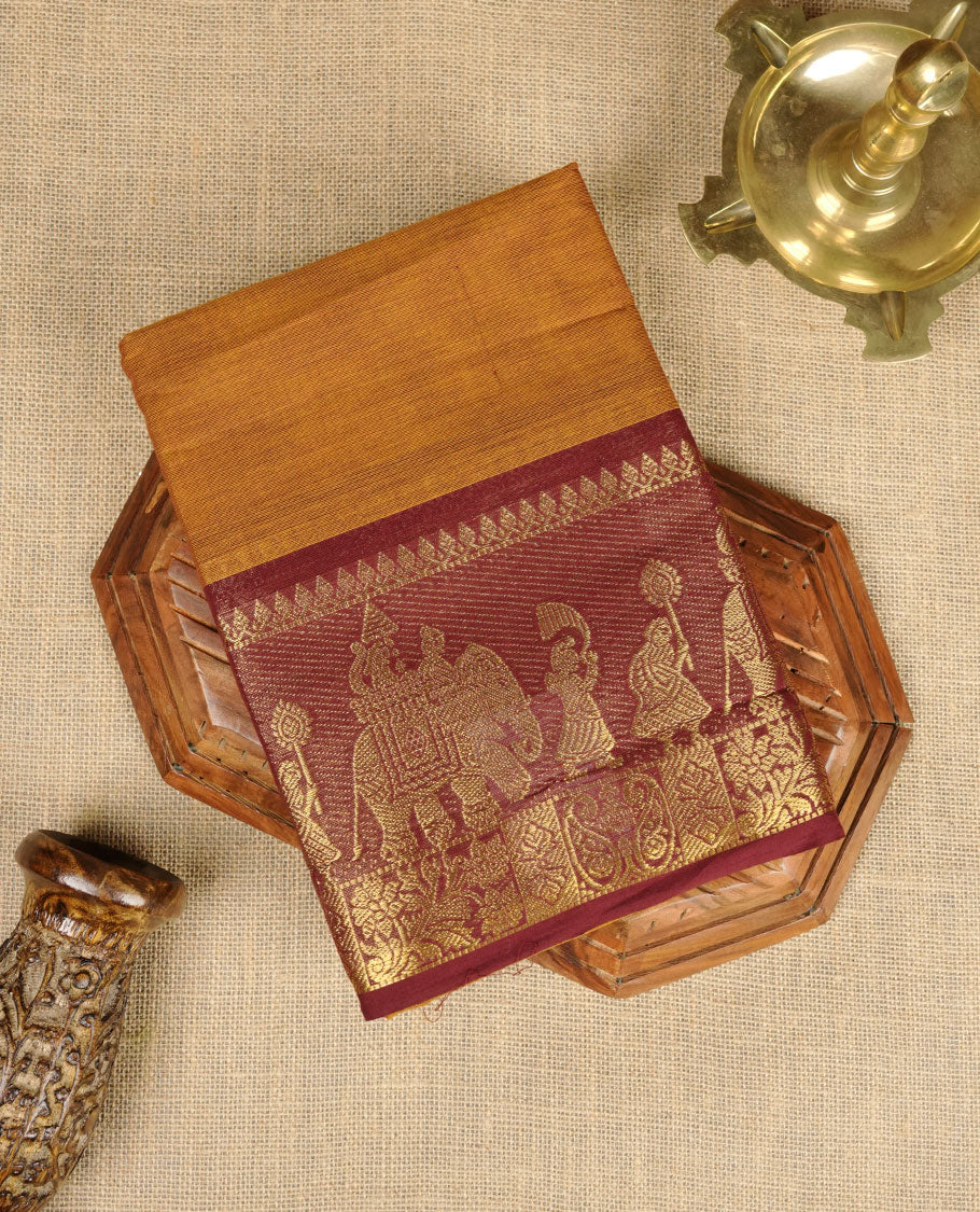 Mustard colour chettinad cotton saree featuring plain body, contrast chocolate brown colour with traditional gold zari border paired with matching blouse.