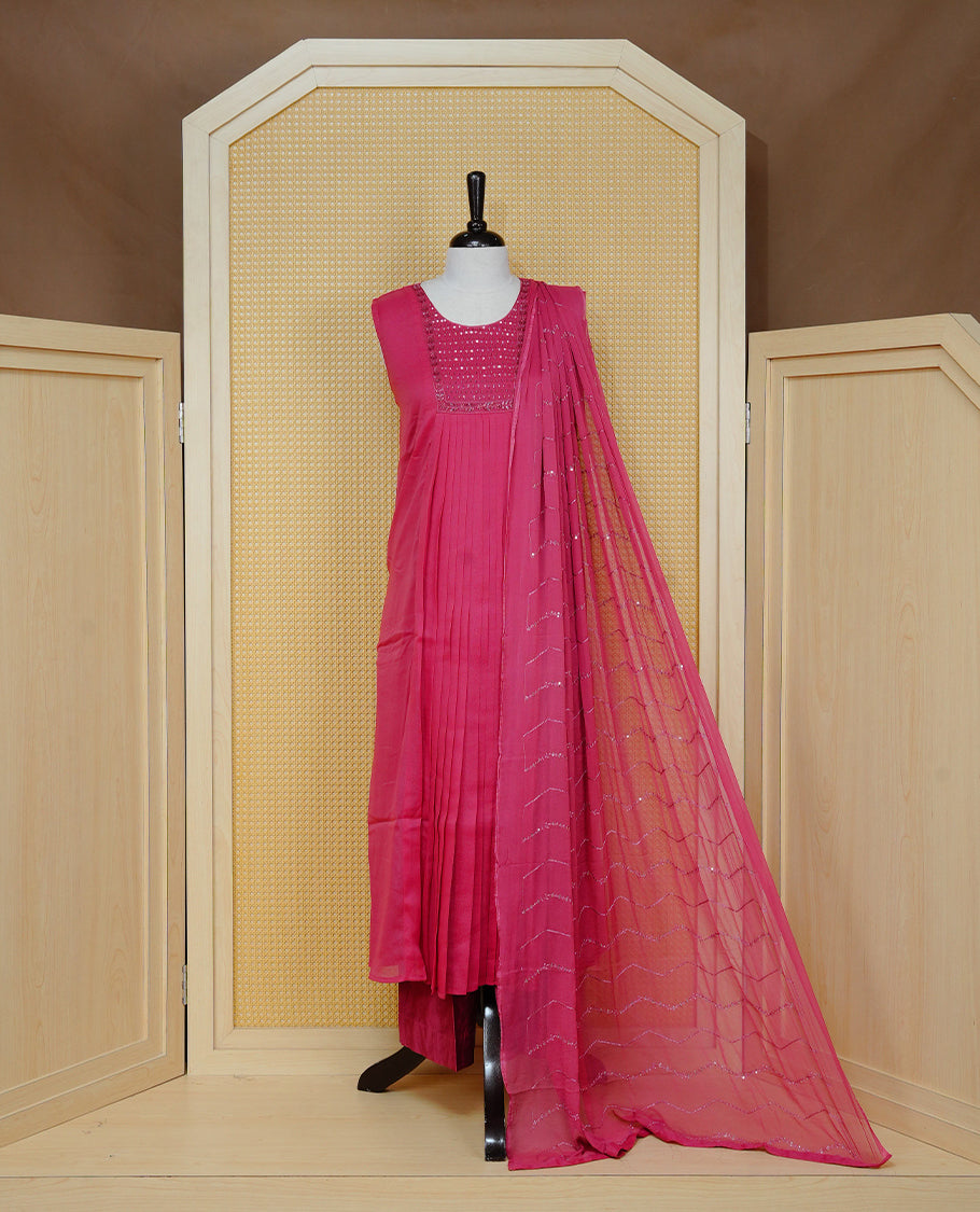 Pastel Raspberry Red Colour churidar set with sequins and bead embroidery on the round neckline, paired with a matching embellished dupatta and solid pants.
