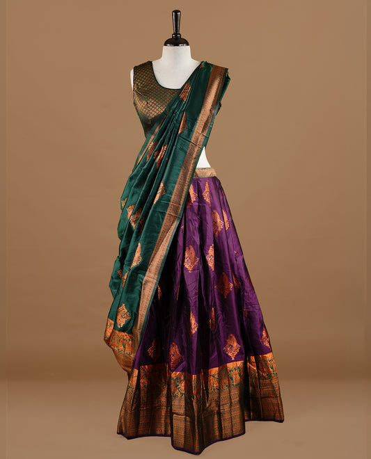 Green colour Half saree featuring Purple colour skirt with contrast green colour traditional border, paired with matching stitched blouse, contrast green dupatta.