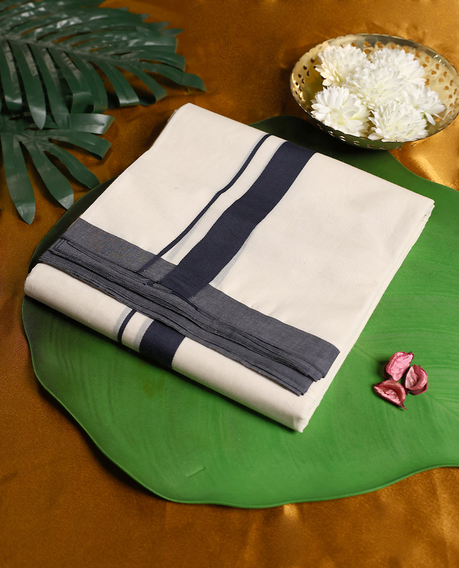 Classic off white colour pure cotton double dhoti featuring a bold navy blue border with fine detailing & A refined traditional attire, perfect for weddings, rituals, and cultural festivities.