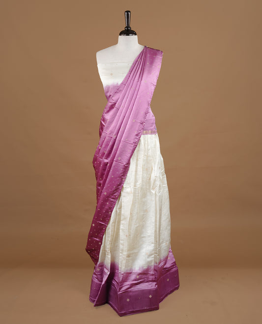 Off White colour half saree material featuring delicate zari buttas on the blouse and skirt, paired with a contrast Pink zari border and matching small zari motifs dupatta
