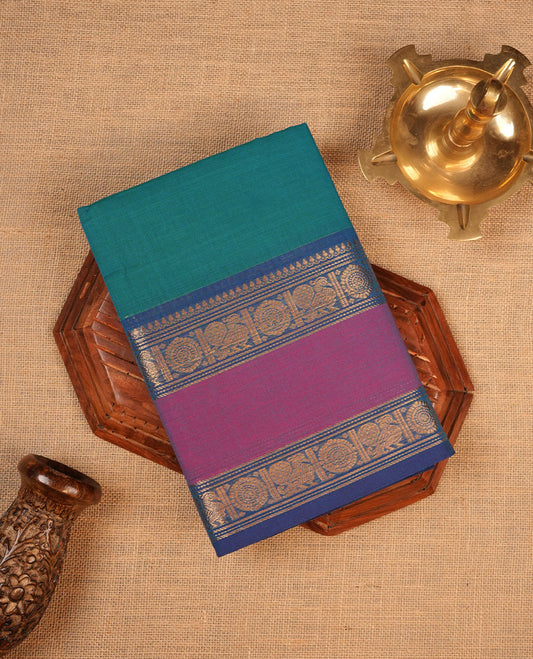 Green colour chettinad cotton saree featuring Elegant plain body highlighting contrast magenta and blue colour with gold zari traditional border, pallu and paired with matching blouse piece.