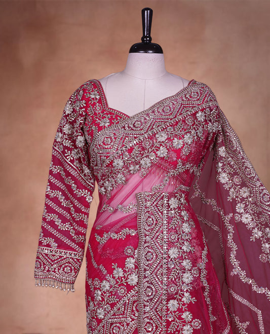 Rani Pink Colour net designer Wedding saree featuring all over floral embroidery with sequin detailing and an ornate scalloped border, finished with a matching embellished blouse.