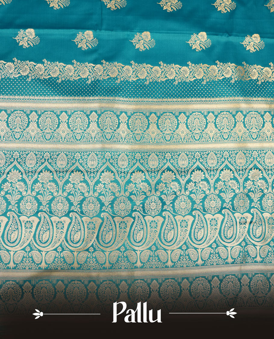 Teal blue colour Banaras Satin Crepe saree featuring gold zari floral motifs on the body, a richly woven traditional border with intricate gold zari detailing, and paired with a matching blouse.