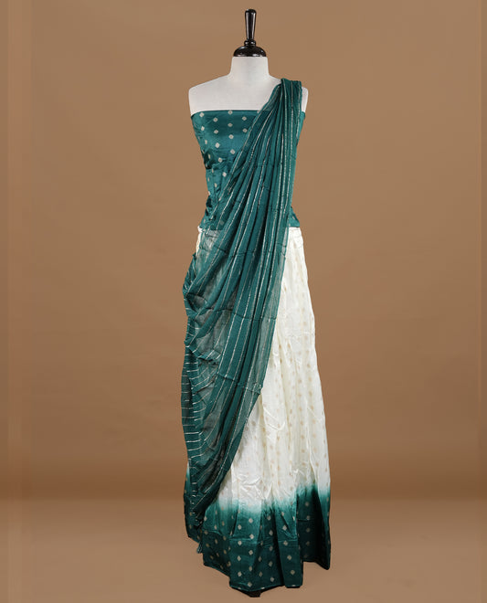 Off white colour semi stitched half saree featuring elegant zari buttas on the body, paired with a contrast green border and matching motifs dupatta,paired with matching blouse piece.
