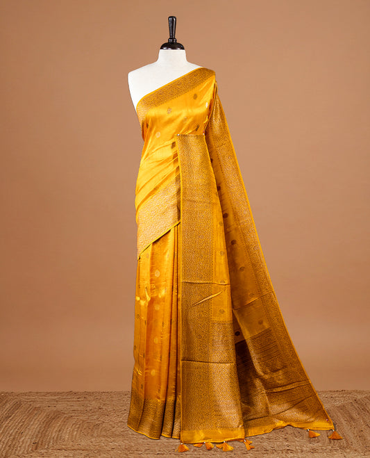 Yellow colour Semi banaras tussar georgette Saree featuring Antique zari motifs on body, enhanced with antique zari border, paired with a matching blouse piece.
