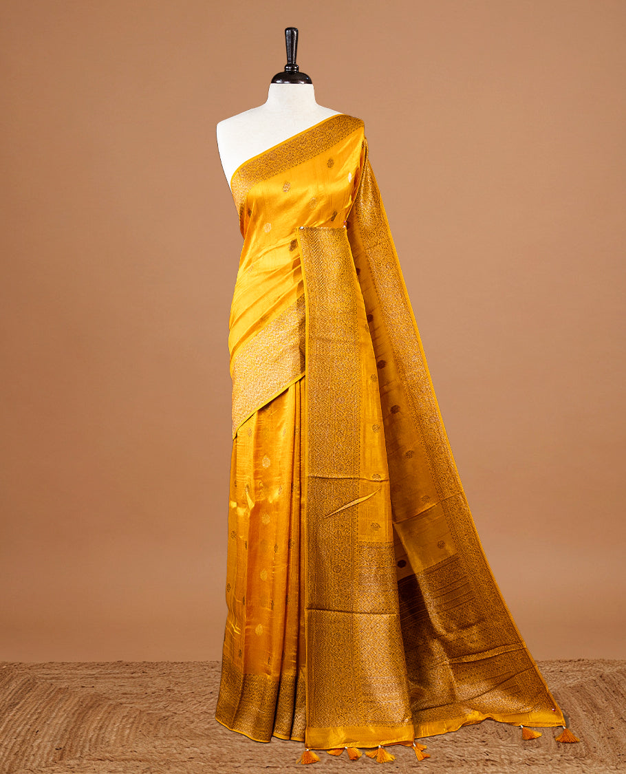 Yellow colour Semi banaras tussar georgette Saree featuring Antique zari motifs on body, enhanced with antique zari border, paired with a matching blouse piece.