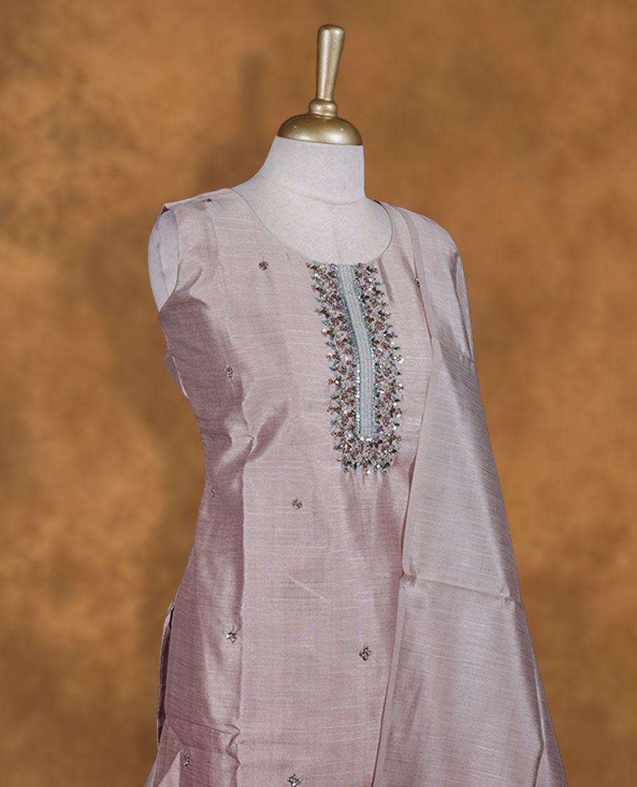 Cream tan colour churidar set featuring elegant white thread embroidery on the neckline, sleeves, and scattered motifs across the body, Paired with a matching embroidered dupatta