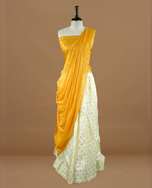 Off white colour semi stitched half saree featuring elegant zari buttas on the body, and contrast mustard colour with striped dupatta,paired with matching blouse piece.