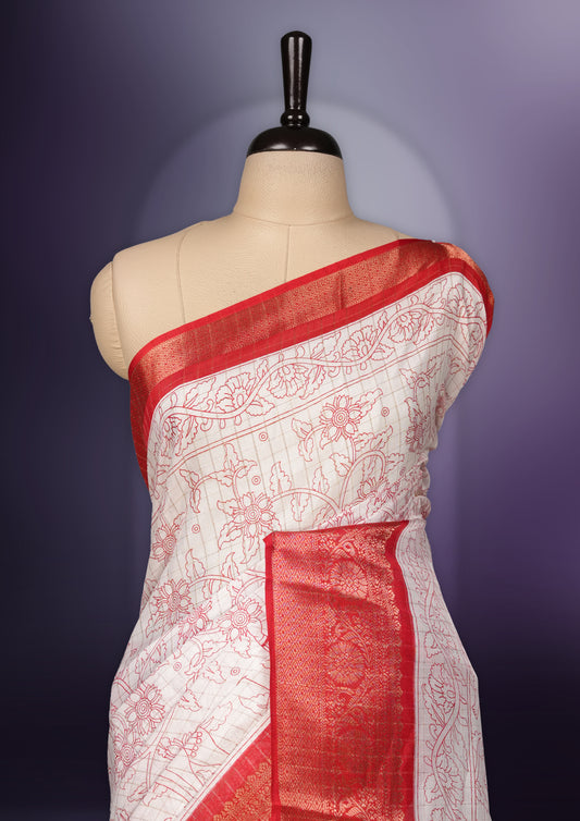 White saree adorned with red motifs, highlighted by a rich red zari border and pallu with traditional patterns and animal designs, paired with a matching blouse.