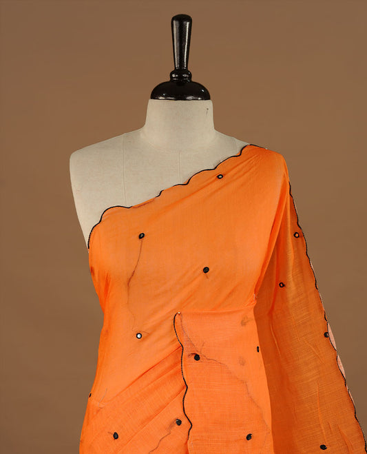 Orange colour Semi Linen saree featuring mirror work with intricate thread detailing, enhanced by a stylish scallop border. Comes without a blouse piece.