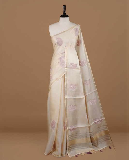 Cream colour Tussar saree featuring Mauve colour Mango pattern with chikankari embroidery work, highlighting gold zari simple border, paired with matching unstitched blouse.