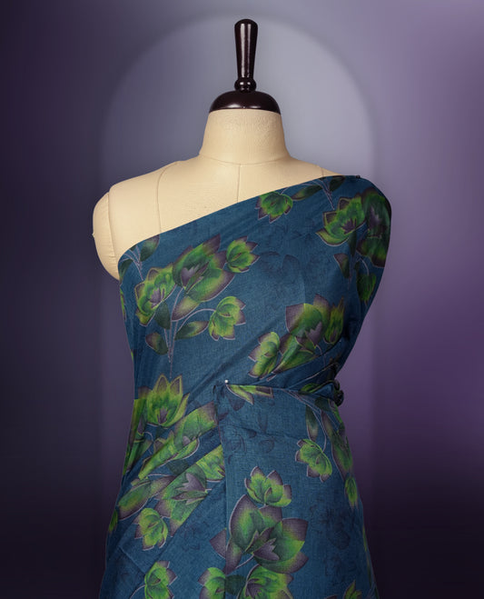 Deep Blue colour saree enhanced with a vibrant green colour floral prints on body & pallu, and  comes with a matching blouse.
