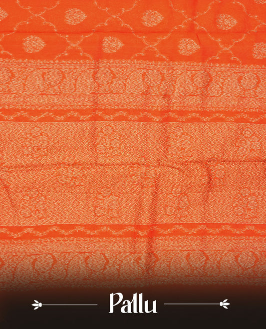 Orange semi Banaras saree with gold zari buta motifs, finished with a traditional gold zari border and pallu, paired with a matching blouse.