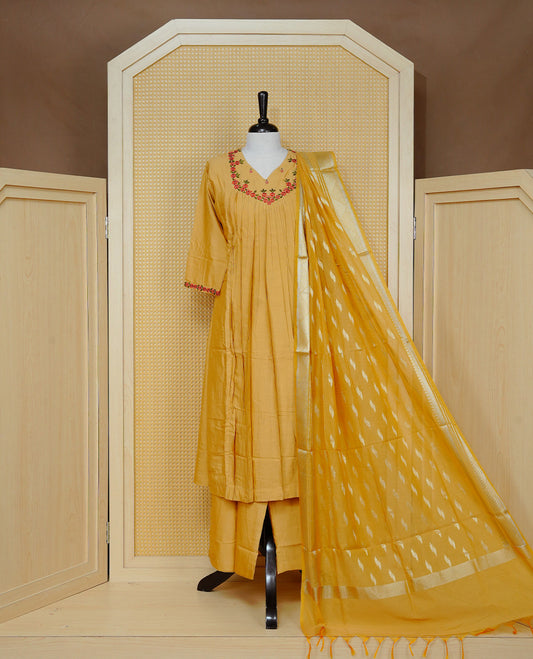 Mustard yellow colour churidar set with floral thread embroidery along the V-neckline and sleeve cuffs, pleated detailing on the front, paired with a matching dupatta and solid pants.