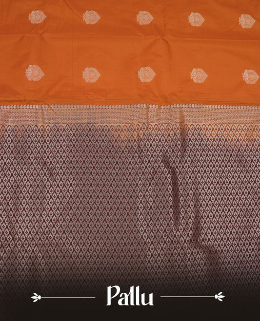 Rust orange colour semi silk saree featuring gold zari floral  motifs on body highlighting contrast dark chocolate rose gold zari peacock border , paired with matching blouse