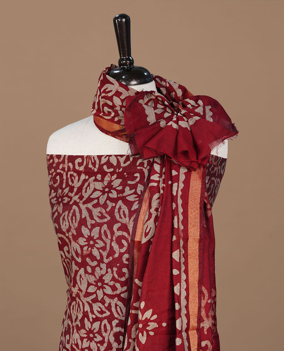Maroon colour churidhar material featuring cream colour floral kodi print on body, paired with matching bottom and Dupatta.