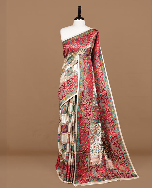 Cream colour Pashmina silk saree features an all over Multi colour box with motifs body, a contrast red peacock border and pallu, and a matching unstitched blouse.