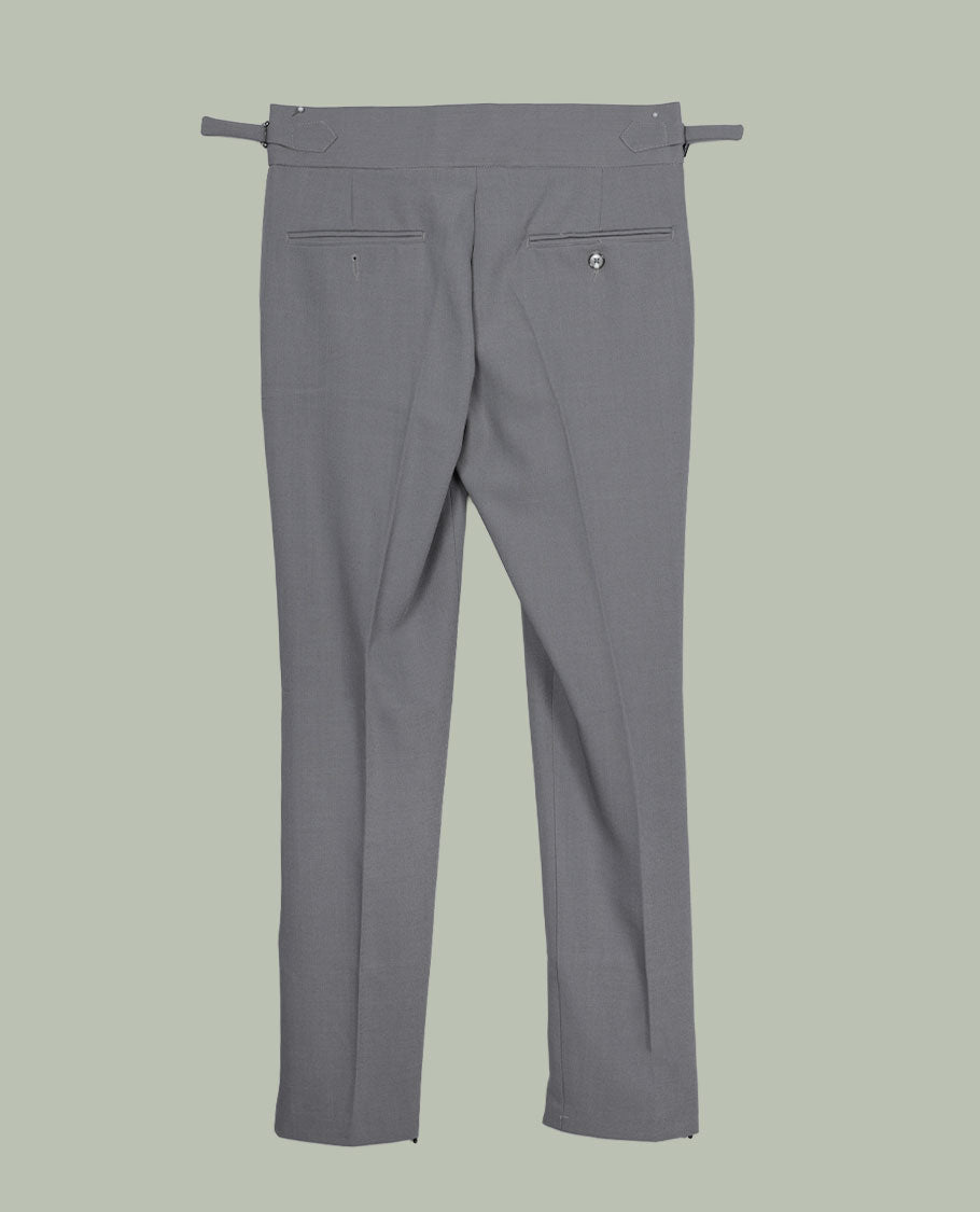 Grey colour men’s pant featuring a clean waistband with side buckle adjusters, neat front pleats, slant pockets and back welt pockets, finished with a straight leg fit.