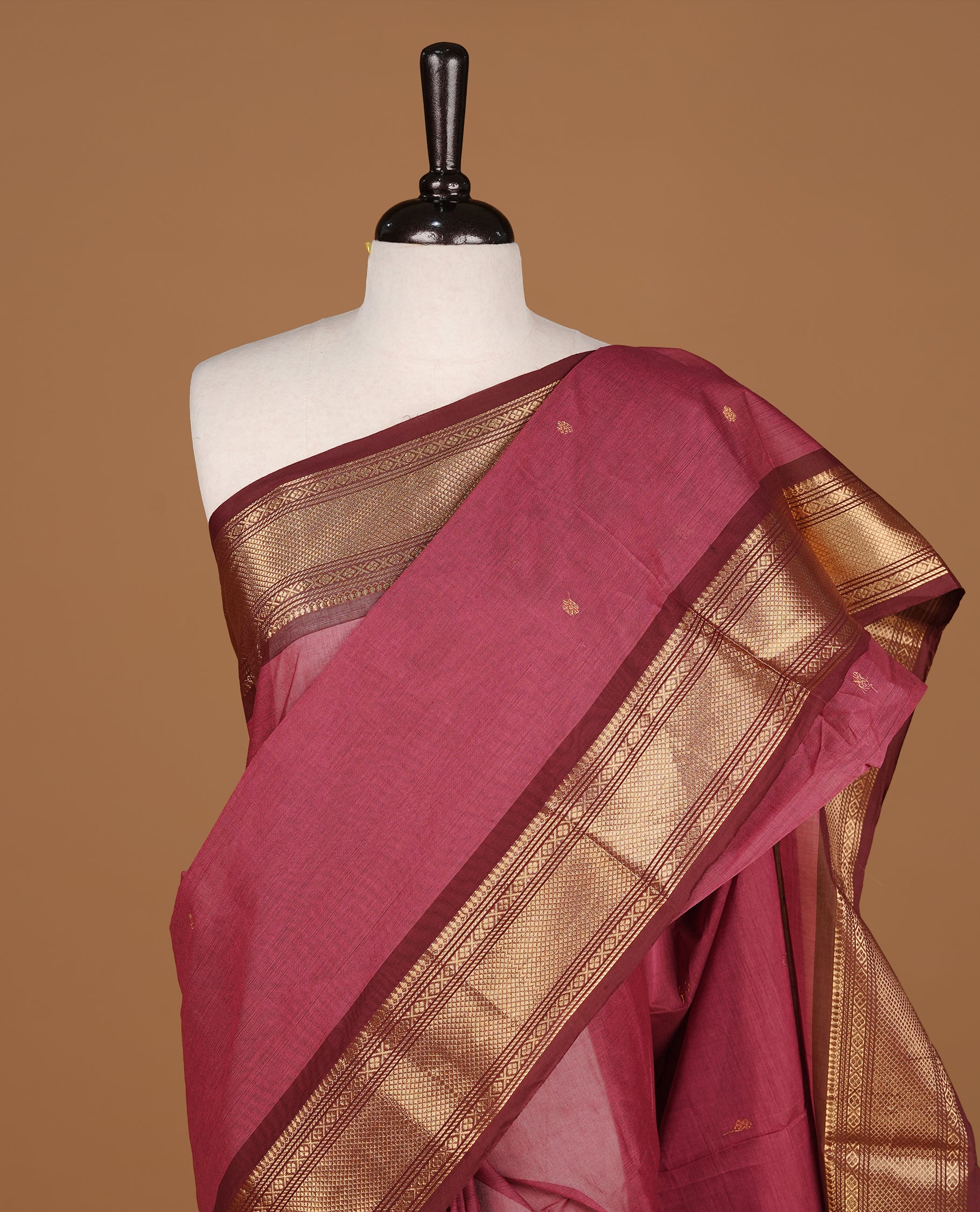 Mauve colour Chettinad cotton saree featuring Gold zari motifs body, complemented by contrast Chocolate Brown colour with gold zari border, paired with matching blouse piece.