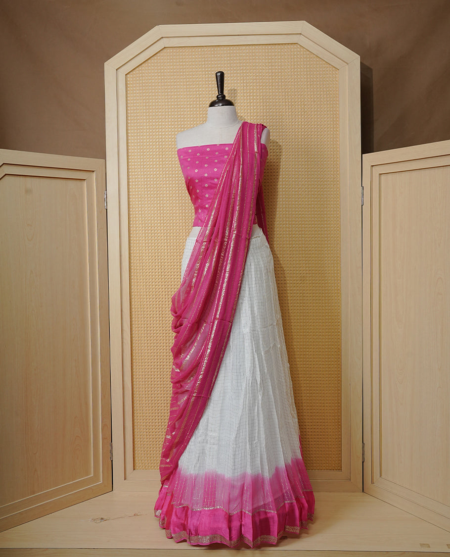 Off white colour Semi stitched dhavani set featuring Gold zari check pattern with contrast Magenta border skirt, paired with matching blouse & dupatta.