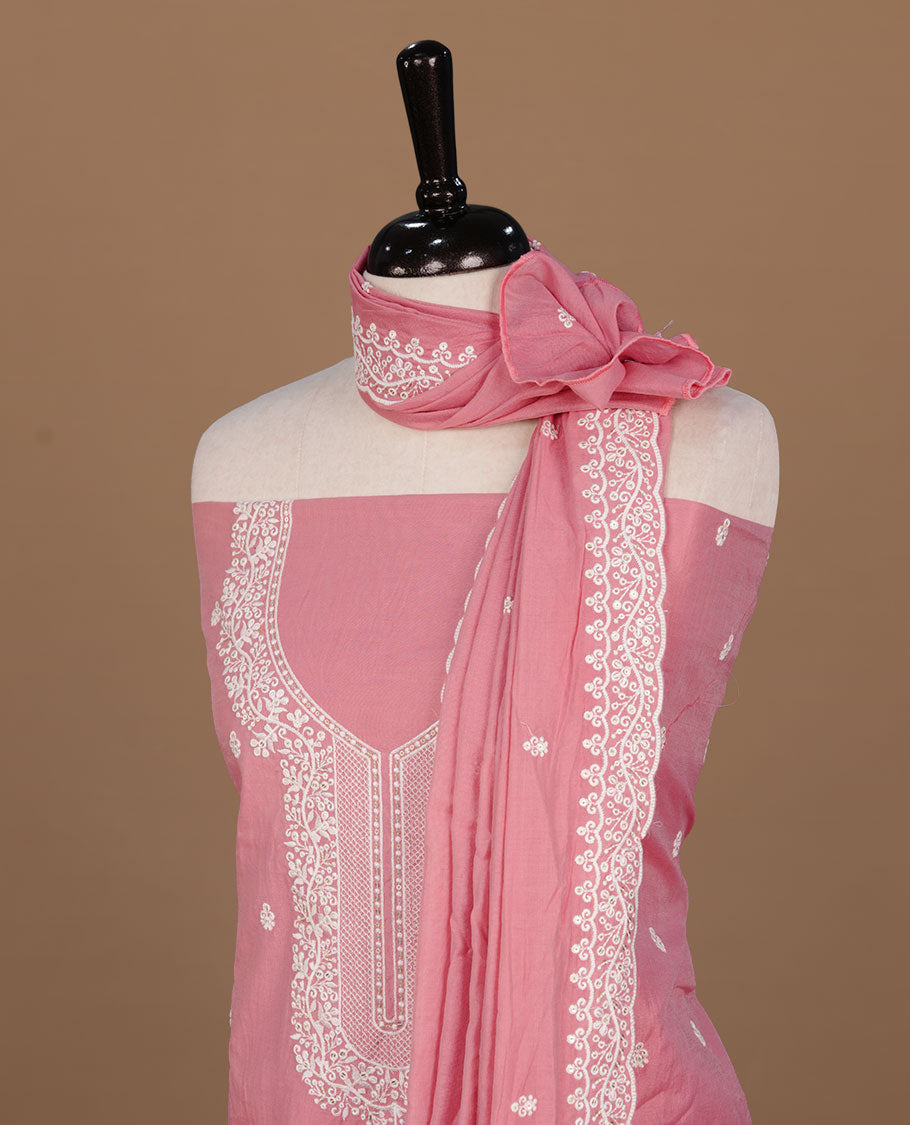 Pastel Peach colour churidar material feating white thread motifs on body and floral kodi pattern neckline, paired with matching bottom and dupatta