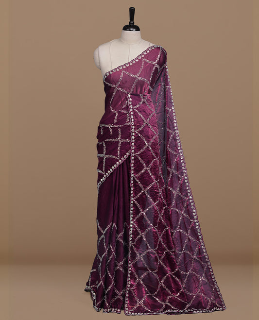 Burgundy colour designer saree featuring Sequins & cut beats worked body, cut beat worked border, paired with matching unstitched blouse.