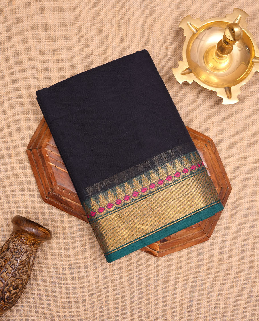 Dark Blue colour chettinad cotton saree featuring Elegant plain body, contrast green colour border with gold zari border, pallu and paired with matching blouse.