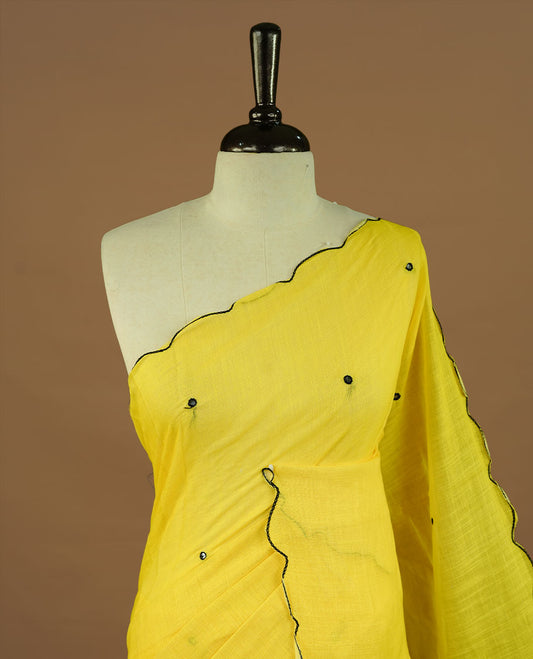 Yellow colour Semi Linen saree featuring mirror work with intricate thread detailing, enhanced by a stylish scallop border. Comes without a blouse piece.