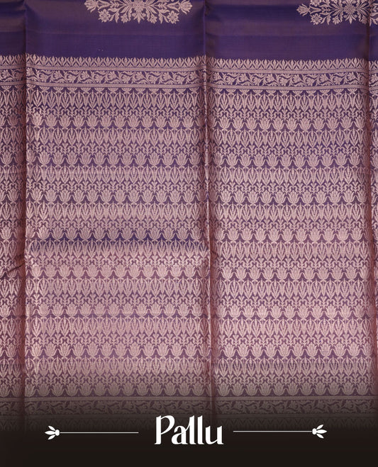 Plum purple colour soft silk saree featuring gold zari motifs on body, complemented by self colour with traditional border with tassel at pallu, paired with matching blouse piece.
