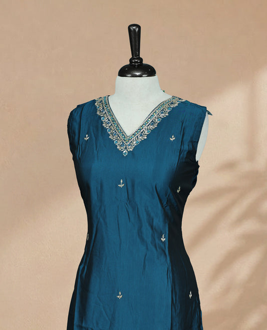 Peacock Blue  Colour Kurti featuring beadwork across the body, a V-shaped neckline adorned with bead and mirror work and a sleeveless design.
