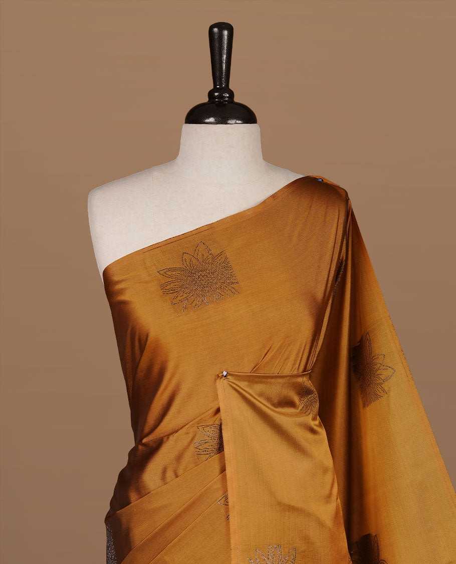 Mustard colour soft silk saree features a sleek borderless design with intricate antique zari motifs, flowing into a striking contrast dark green pallu and a matching blouse piece.