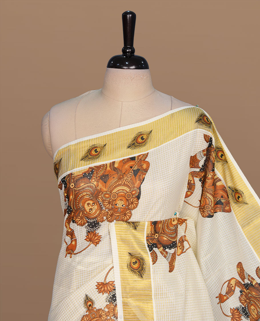 Off white color kerala cotton saree featuring gold zari check on body, complemented by, gold zari with krishna & peacock leaf printed border, paired with matching blouse piece.