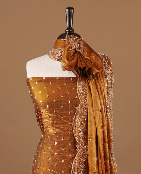 Brown colour churidhar material featuring cut beads and sequins work on the body, paired with a matching unstitched bottom and worked dupatta.