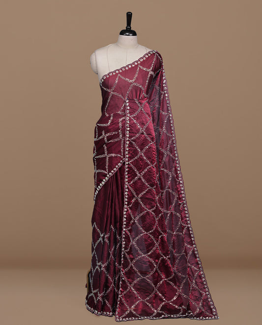 Maroon colour designer saree featuring Sequins & cut beats worked body, cut beat worked border, paired with matching unstitched blouse.