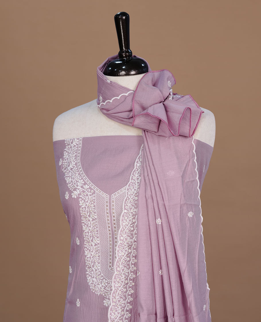 Pastel Purple colour churidar material feating white thread motifs on body and floral kodi pattern neckline, paired with matching bottom and dupatta
