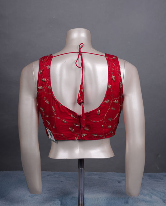 Red colour embroidered padded blouse with gold vine detailing, V neckline, and tie-back finish.