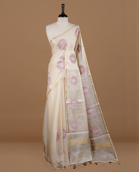 Cream colour Tussar saree featuring mauve colour circle pattern with chikankari embroidery work, highlighting gold zari simple border, paired with matching unstitched blouse.