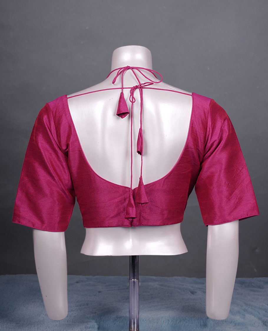 Solid Magenta colour silk padded readymade blouse with elbow-length sleeves, a V-neck front, and a deep U-back with tie-up dori.