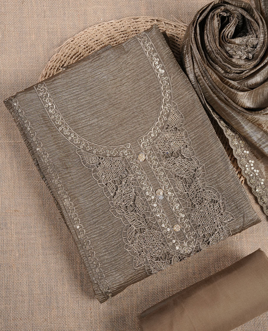 Taupe brown churidar suit material with lace embroidery and subtle sequin detailing on the neckline, paired with a matching textured dupatta and plain bottom.