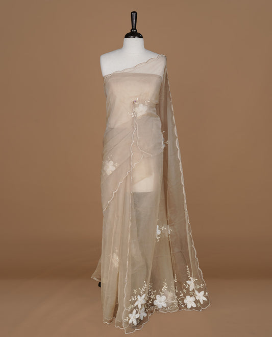 Light coffee colour crush organza saree featuring white floral work with beats & sequins, highlighting scalp with beats worked border, paired with matching blouse piece.