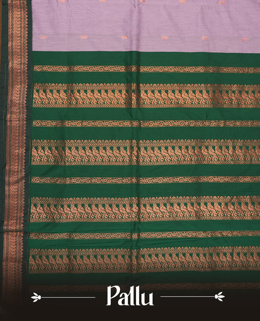 Lavender colour Kalyani Cotton saree with delicate woven zari motifs all over, paired with a contrasting deep green border and pallu intricately woven with rich copper peacock zari & Comes with a matching blouse piece.