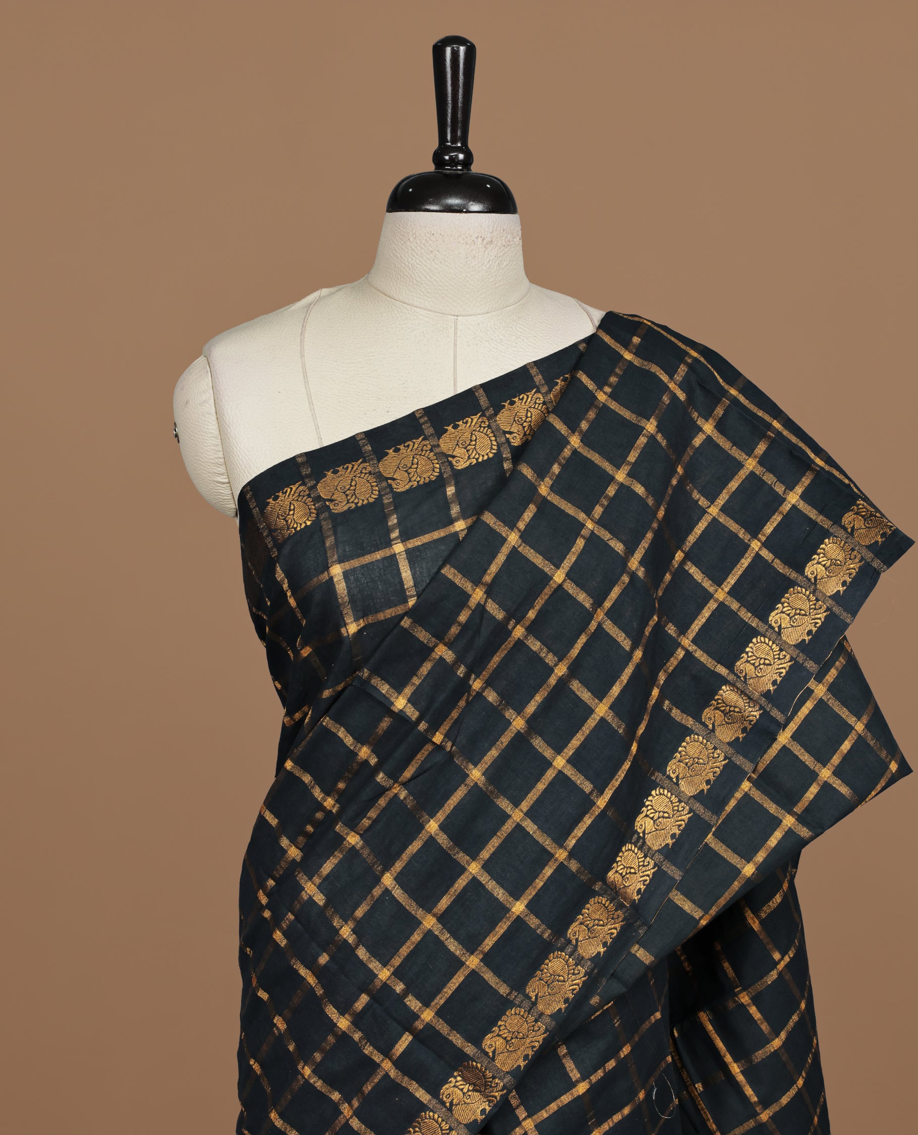 Black colour Sungudi cotton saree featuring Gold zari Check pattern on body, Gold zari Peacock design on Self colour border, paired with matching blouse piece.