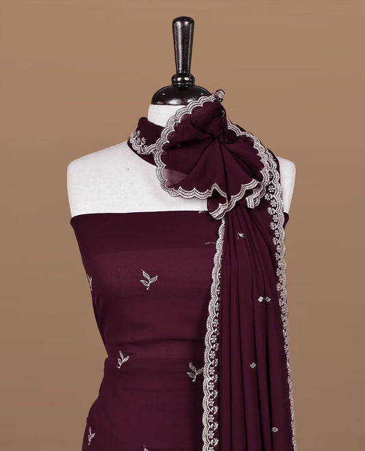 Maroon colour churidhar material featuring gold thread floral pattern on body, paired with matching bottom & dupatta.