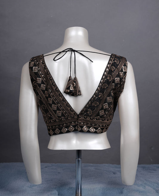 Black colour embroidered sleeveless blouse with intricate geometric motifs, deep V neckline, and tie-up back detailing for a chic finish.