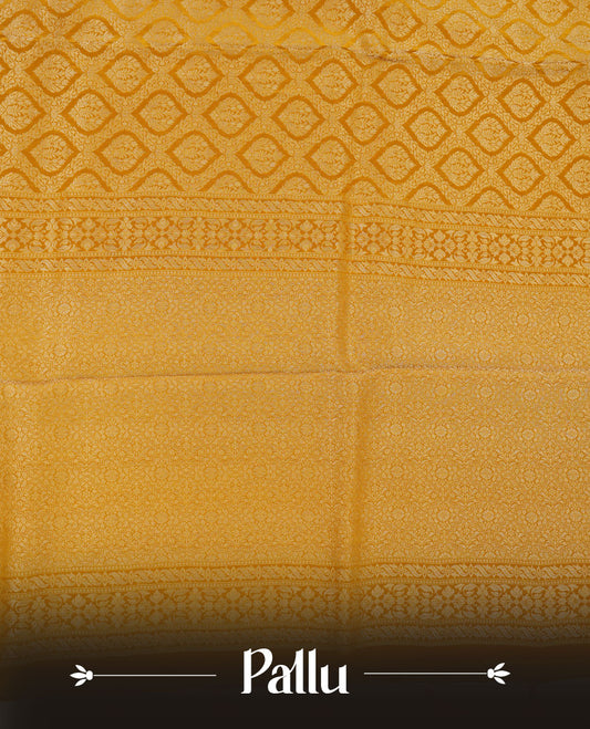 Yellow colour banaras satin crepe saree featuring gold zari pattern across body, with self colour border with gold zari pattern and paired with matching blouse.