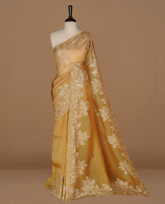Gold colour organza saree featuring thread & cut beats, sequins leaf pattern on body, highlighting scalp border, paired with matching blouse piece.