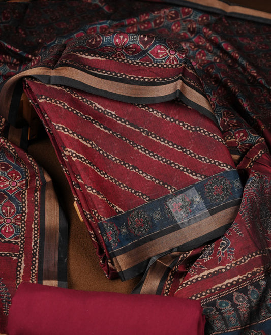 Maroon colour churidar material featuring a striped printed body, paired with an intricately printed dupatta and a matching solid bottom.