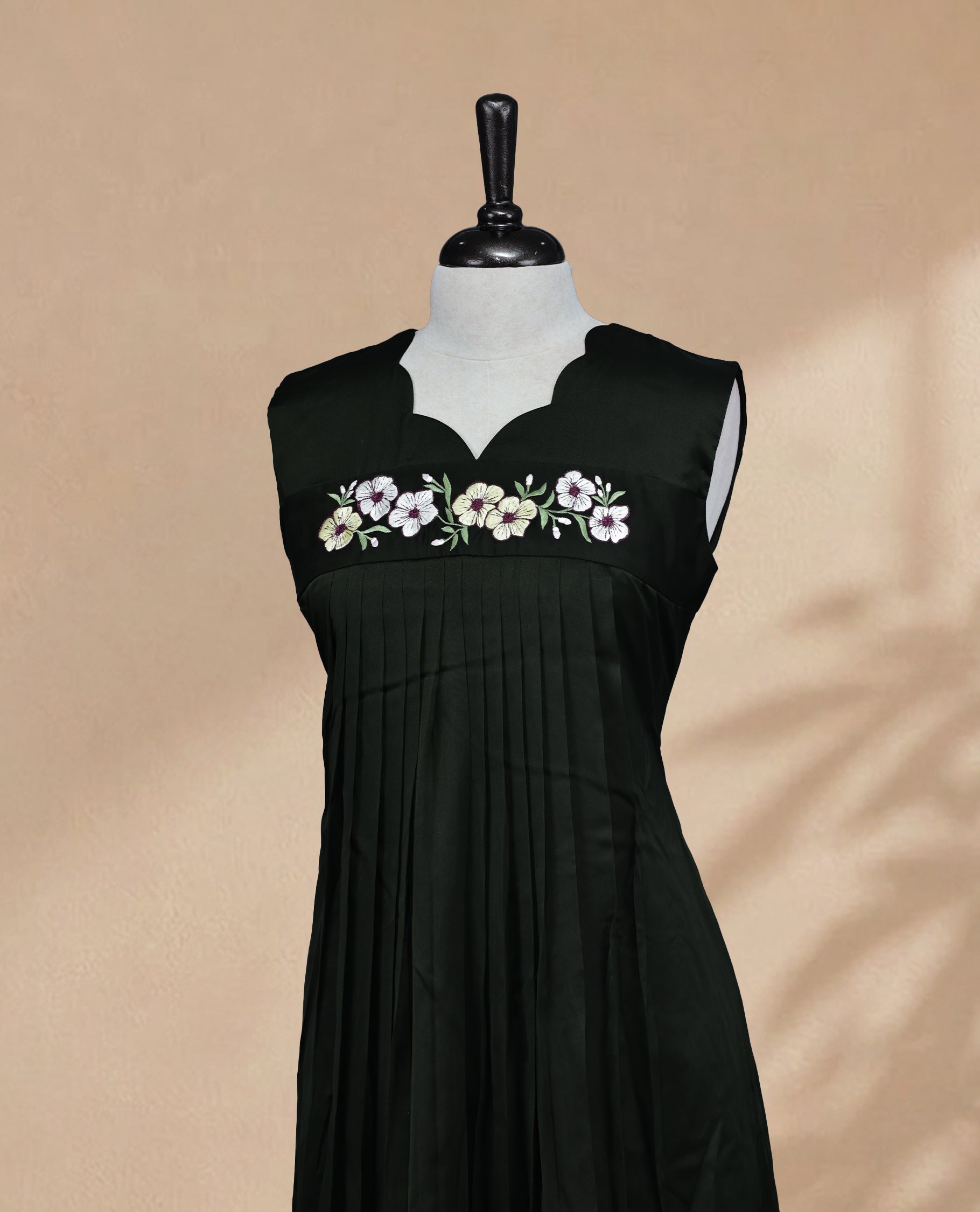 Deep Forest Green Coloured Sleeveless Kurti Featuring a Designed Neckline, Floral Embroidery on the Body
